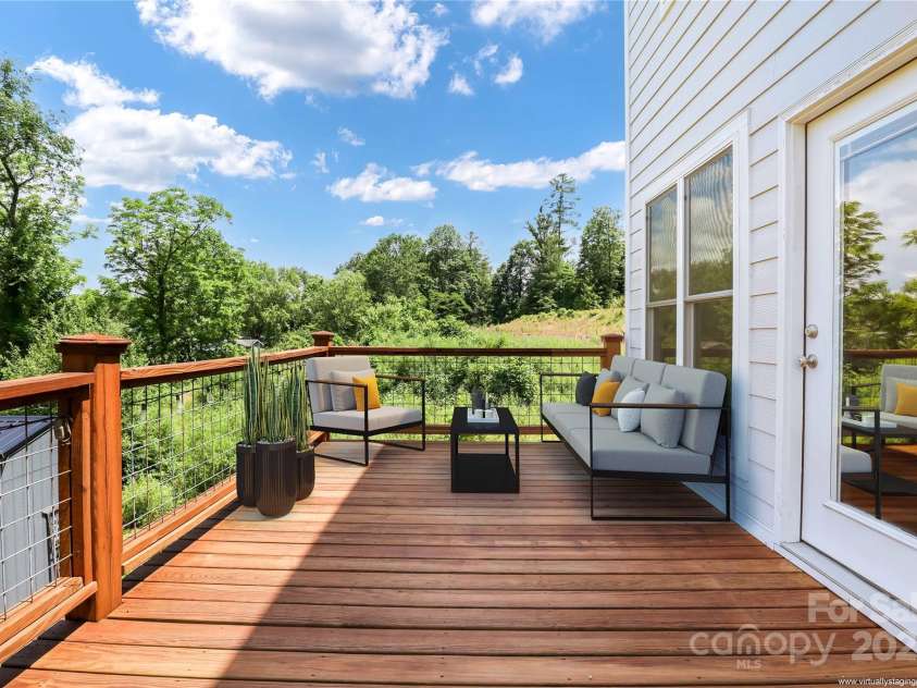 108 Course Drive, Etowah, NC 28729.  MLS# CAR4216088, YatesRealty ID 7406. Expansive outdoor living with space for multiple seating options (virtually staged)