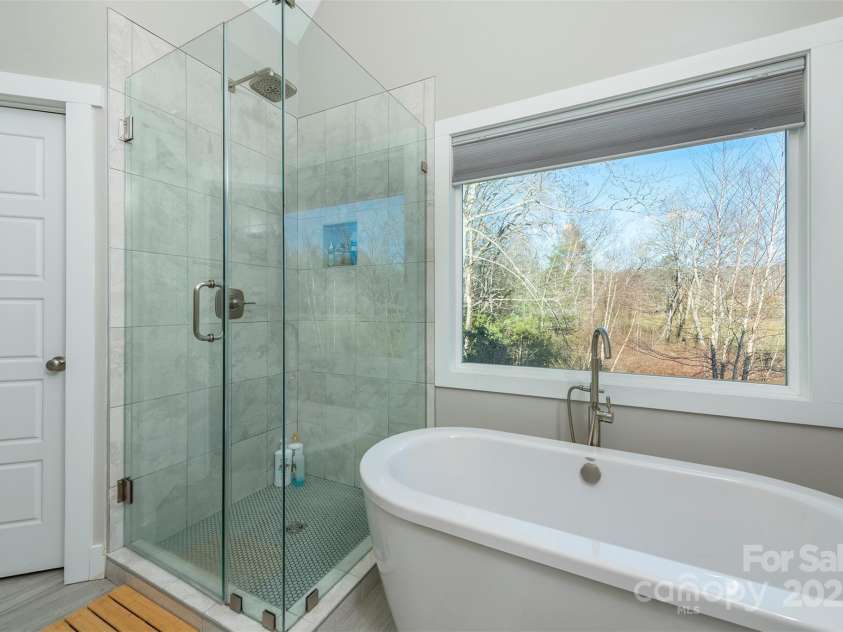 108 Course Drive, Etowah, NC 28729.  MLS# CAR4216088, YatesRealty ID 7406. Luxurious glass enclosed shower in the primary