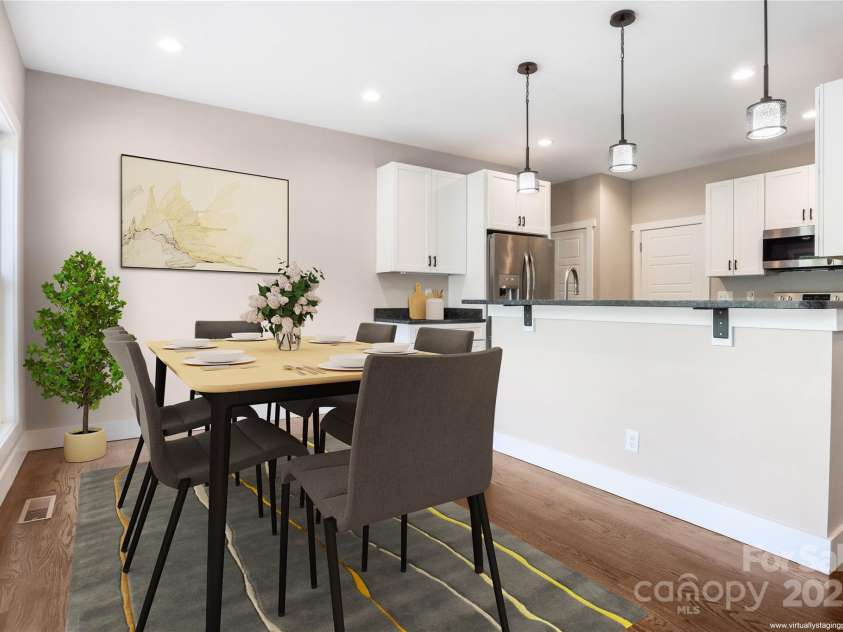 108 Course Drive, Etowah, NC 28729.  MLS# CAR4216088, YatesRealty ID 7406. Spacious additional dining area with open flow to kitchen and living space with access to large back deck (virtually staged)