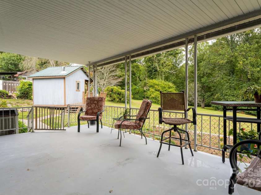 3870 Kanuga Road, Hendersonville, NC 28739.  MLS# CAR4209718, YatesRealty ID 7420. Covered Back Porch and Storage Shed