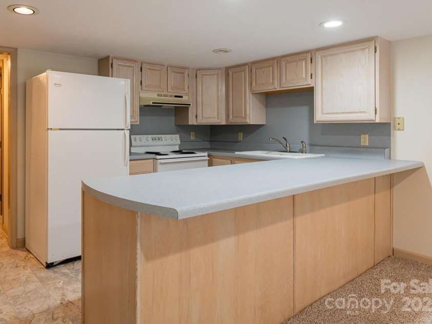 3870 Kanuga Road, Hendersonville, NC 28739.  MLS# CAR4209718, YatesRealty ID 7420. Downstairs Kitchen