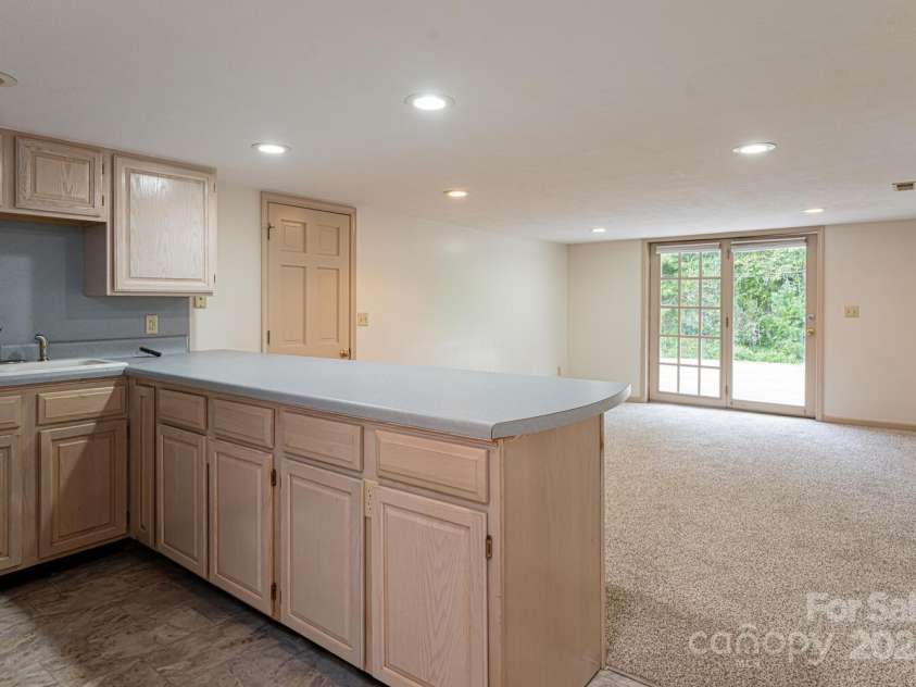 3870 Kanuga Road, Hendersonville, NC 28739.  MLS# CAR4209718, YatesRealty ID 7420. Downstairs Kitchen & Living Area