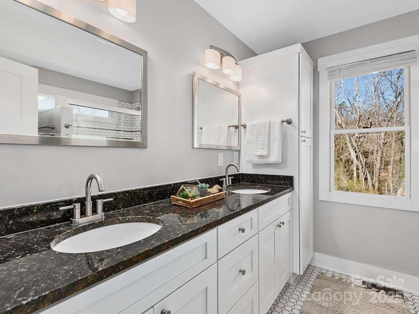 34 Walnut Lane, Asheville, NC 28804.  MLS# CAR4233293, YatesRealty ID 7421. En-suite bathroom features double-sink vanity with ample storage, tile flooring & shower surround, and modern finishes throughout