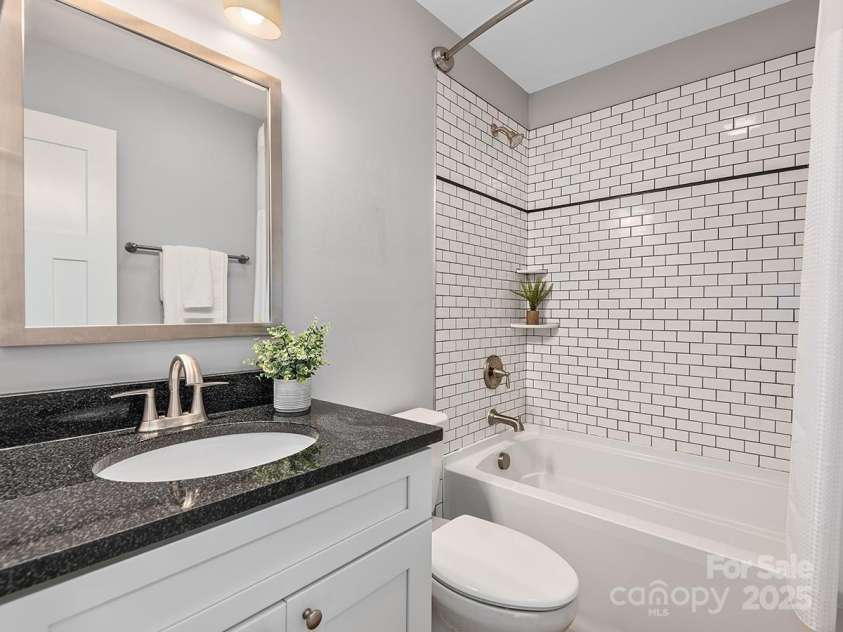 34 Walnut Lane, Asheville, NC 28804.  MLS# CAR4233293, YatesRealty ID 7421. Second full bath on upper level with tile finishes and contemporary fixtures