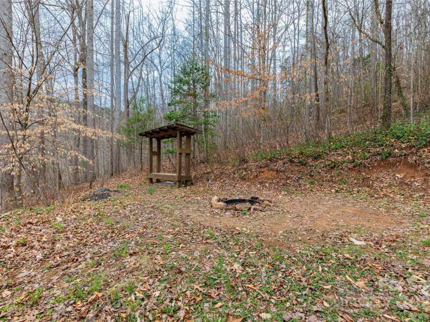 63 Wabash Drive, Sylva, NC 28779.  MLS# CAR4244141, YatesRealty ID 7425. Firepit and wood shed