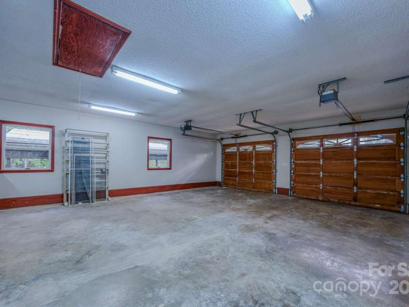 35 Byrd Road, Candler, NC 28715.  MLS# CAR4314143, YatesRealty ID 743. Large attached garage with work/shop area