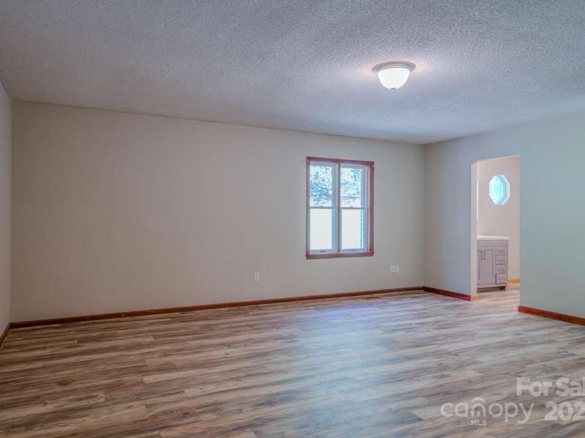 35 Byrd Road, Candler, NC 28715.  MLS# CAR4314143, YatesRealty ID 743. Primary bedroom with en suite bathroom