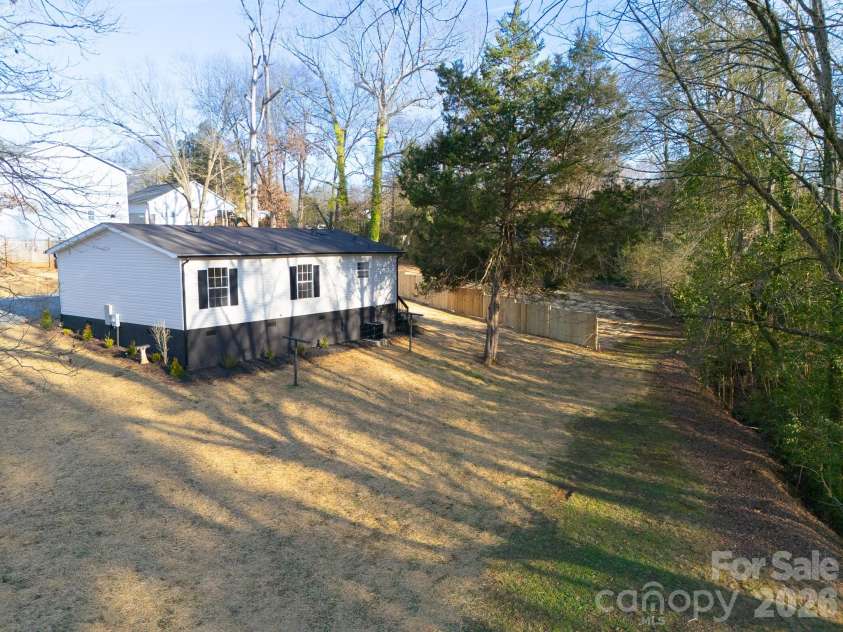 3313 Weeping Willow Drive, Concord, NC 28027.  MLS# CAR4349604, YatesRealty ID 7432. Side view, property line 