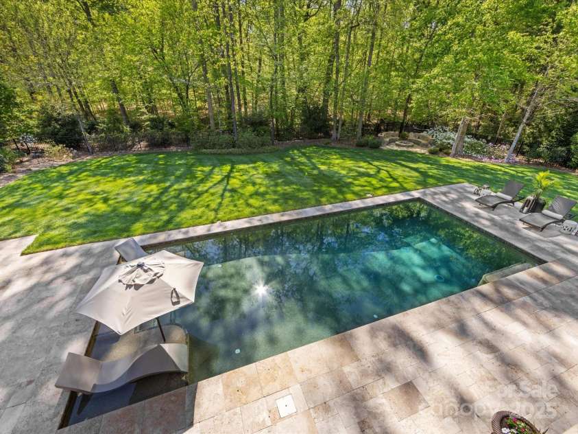1012 Shippon Lane, Waxhaw, NC 28173.  MLS# CAR4244187, YatesRealty ID 7442. Lounger chairs sit inside pool.