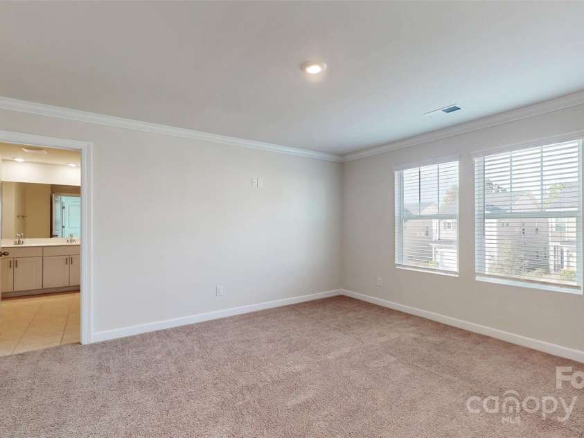 527 Palmarosa Street, Fort Mill, SC 29715.  MLS# CAR4320377, YatesRealty ID 745. Primary Bedroom with view of the Primary Bathroom