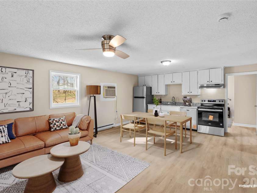 126 Thomas Street, Troutman, NC 28166.  MLS# CAR4355493, YatesRealty ID 7478. Virtually Staged Great Room, Dining, Kitchen