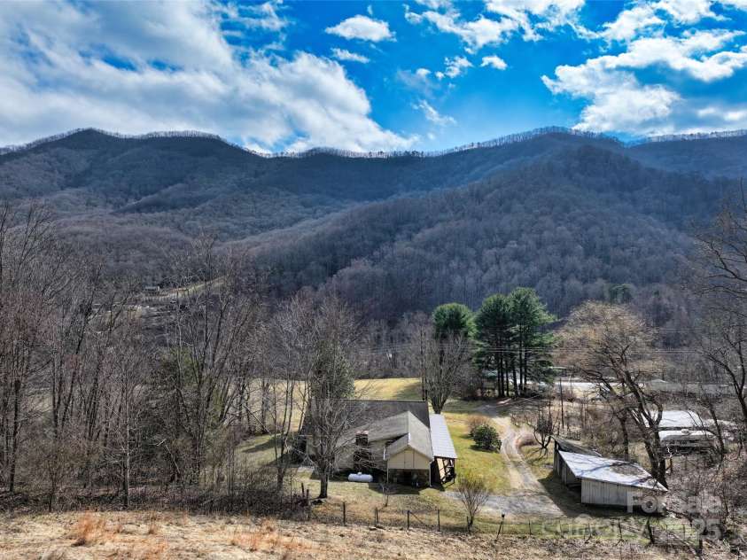1567 Newfound Road, Leicester, NC 28748.  MLS# CAR4214973, YatesRealty ID 7479. Further up on land looking down on home winter