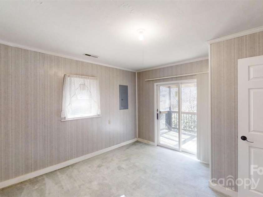 1567 Newfound Road, Leicester, NC 28748.  MLS# CAR4214973, YatesRealty ID 7479. Sliders to covered porch off primary bedroom
