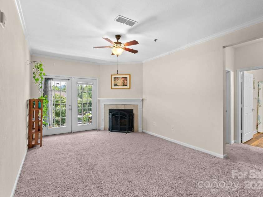 400 Vista Lake Drive, Candler, NC 28715.  MLS# CAR4222116, YatesRealty ID 7505. Livingroom with wood burning fireplace
