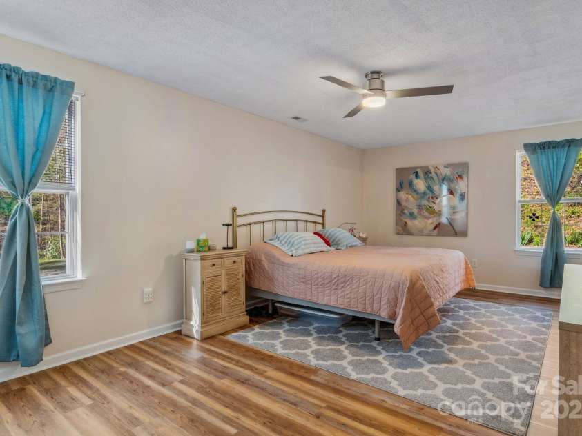 12 Hutchinson Woods Drive, Fletcher, NC 28732.  MLS# CAR4238385, YatesRealty ID 752. This serene haven features ample natural light, generous closet space, and direct access to a beautifully appointed ensuite bathroom