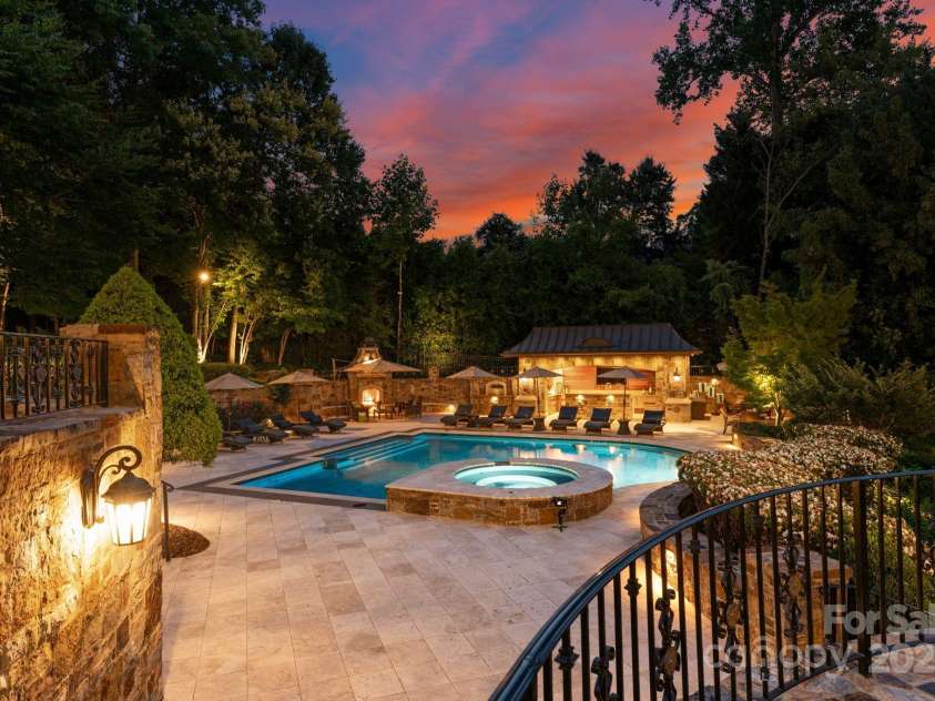 4536 Fox Brook Lane, Charlotte, NC 28211.  MLS# CAR4157549, YatesRealty ID 7532. Back terraces overlook the saltwater pool and hot tub. Travertine patio decking with hand chipped stone hardscaping, and lush manicured landscaping.