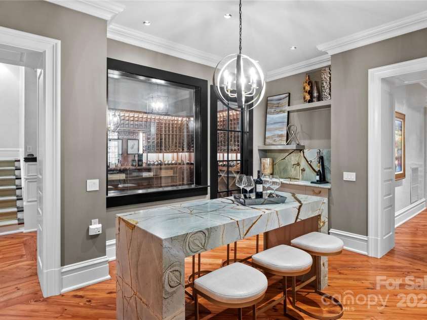 4536 Fox Brook Lane, Charlotte, NC 28211.  MLS# CAR4157549, YatesRealty ID 7532. Blue Roma Quartzite tasting table and wet bar with hammer copper sink and wall mounted faucet.
