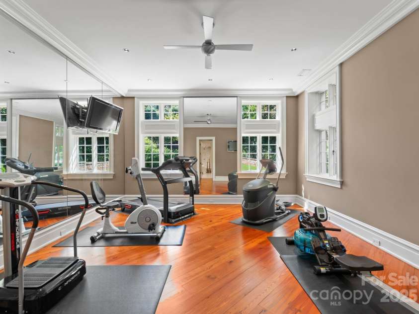 4536 Fox Brook Lane, Charlotte, NC 28211.  MLS# CAR4157549, YatesRealty ID 7532. Fitness/Yoga Studio/6th bedroom. Floor to ceiling mirrors, ceiling fan, and TV’s.