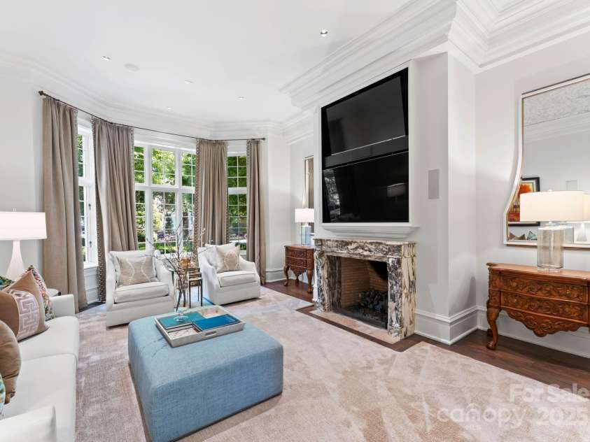 4536 Fox Brook Lane, Charlotte, NC 28211.  MLS# CAR4157549, YatesRealty ID 7532. Hearth Room offers spacious and comfortable room with rich accents, fireplace, and custom furniture.