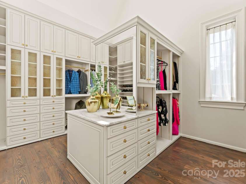 4536 Fox Brook Lane, Charlotte, NC 28211.  MLS# CAR4157549, YatesRealty ID 7532. Large primary closet with built-in closet system, jewelry station, vaulted ceilings,and skylights.