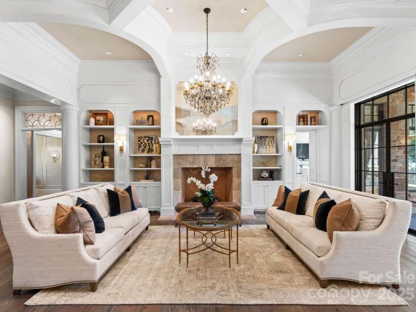 4536 Fox Brook Lane, Charlotte, NC 28211.  MLS# CAR4157549, YatesRealty ID 7532. Library offers built-ins with backlighting, Visual Comfort sconces, and oversized French imported fireplace.