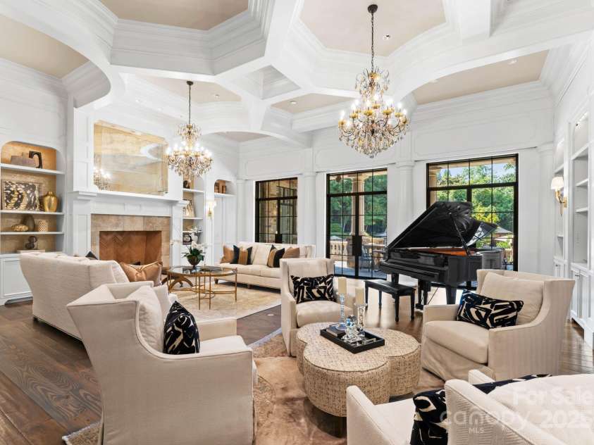 4536 Fox Brook Lane, Charlotte, NC 28211.  MLS# CAR4157549, YatesRealty ID 7532. Library with dual Schonbeck custom crystal chandeliers. Custom Furniture by Massoud and CR Laine, and  Grand Piano.