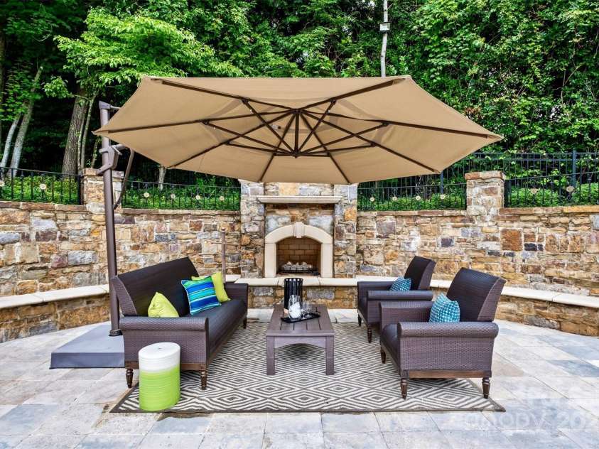 4536 Fox Brook Lane, Charlotte, NC 28211.  MLS# CAR4157549, YatesRealty ID 7532. Outdoor gas fireplace, bench seating, and water feature/fountain