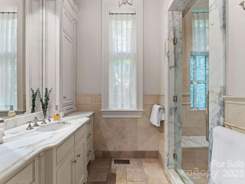 4536 Fox Brook Lane, Charlotte, NC 28211.  MLS# CAR4157549, YatesRealty ID 7532. Primary bathroom includes separate spacious water closets with bidet, walk-in shower with Waterworks fixtures. Ceiling accent lighting.