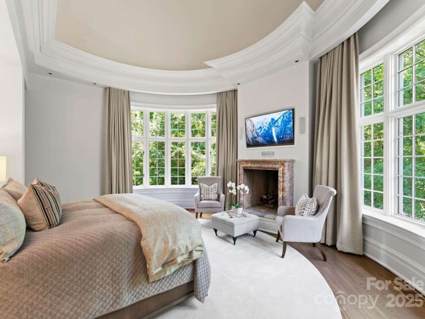 4536 Fox Brook Lane, Charlotte, NC 28211.  MLS# CAR4157549, YatesRealty ID 7532. Primary bedroom with 90” windows and 180 degree views. Vaulted ceiling with intricate crafted molding, new drapery, and coffee and beverage station.