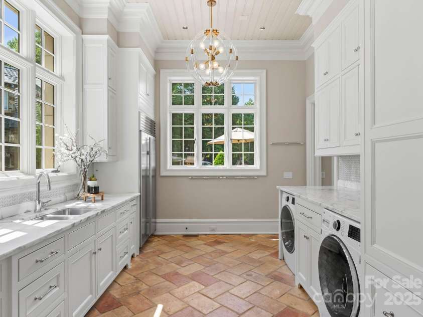 4536 Fox Brook Lane, Charlotte, NC 28211.  MLS# CAR4157549, YatesRealty ID 7532. Scullery includes laundry and folding station, additional floor to ceiling cabinetry, and secondary built-in Subzero Refrigerator.