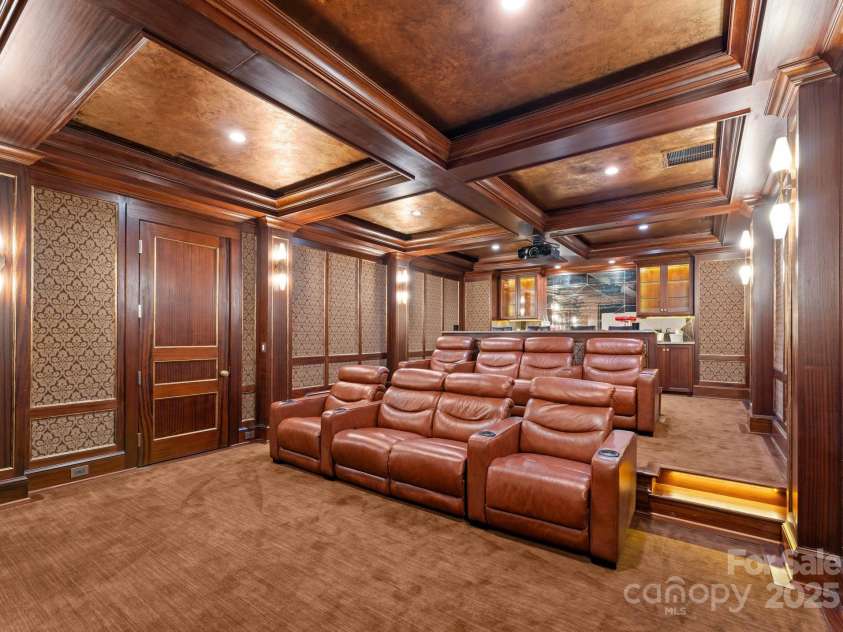 4536 Fox Brook Lane, Charlotte, NC 28211.  MLS# CAR4157549, YatesRealty ID 7532. Stadium seating with eight luxury leather reclining chairs, bar top, prep, and additional cabinetry with antique mirror backsplash.