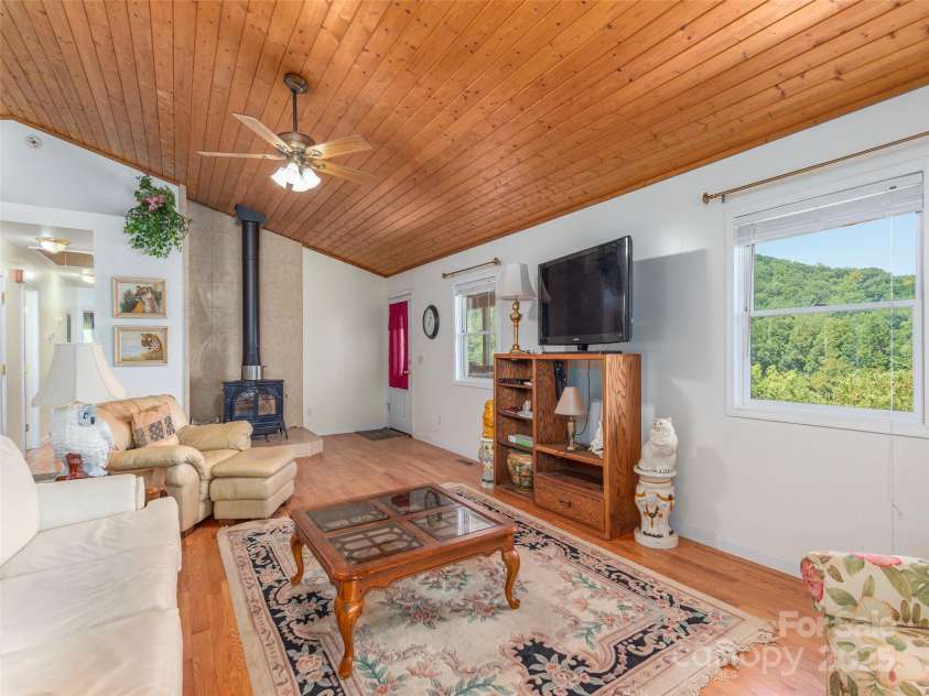 1120 Jacobs Branch Road, Franklin, NC 28734.  MLS# CAR4176894, YatesRealty ID 7545. Living room w/woodburning stove