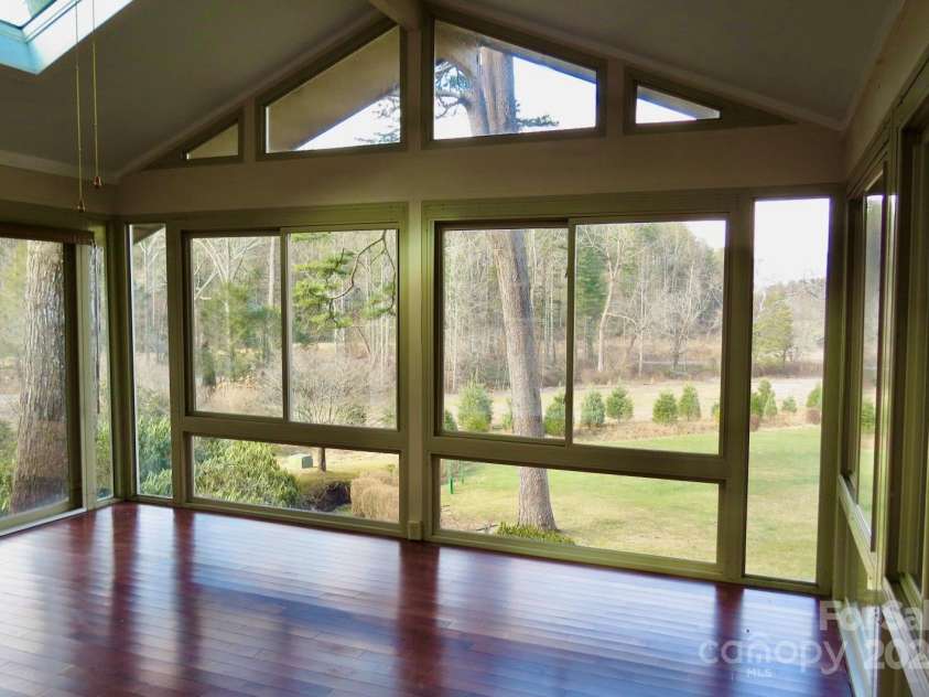 871 Glen Cannon Drive, Pisgah Forest, NC 28768.  MLS# CAR4216993, YatesRealty ID 7558. Sunroom has a vaulted ceiling and wood flooring