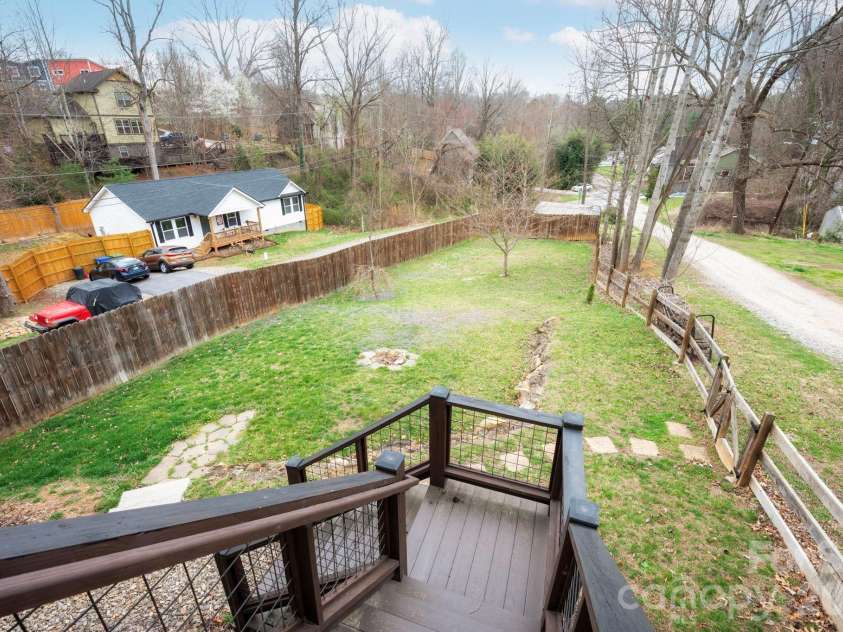 31 Central Avenue, Asheville, NC 28806.  MLS# CAR4355209, YatesRealty ID 7563. Large, sunny, open, usable back yard.