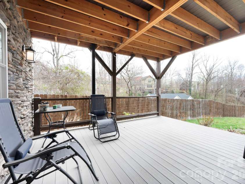 31 Central Avenue, Asheville, NC 28806.  MLS# CAR4355209, YatesRealty ID 7563. Lower level private back deck opening up into fully fenced in back yard