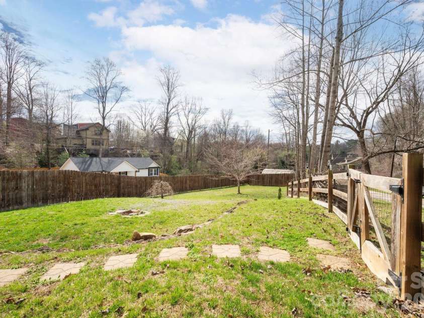 31 Central Avenue, Asheville, NC 28806.  MLS# CAR4355209, YatesRealty ID 7563. Sunny yard with a detached storage shed