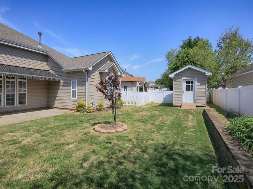 126 Dairy Farm Road, Mooresville, NC 28115.  MLS# CAR4245594, YatesRealty ID 7577. Spacious Fenced back yard with Storage Shed and small fenced off area that could be used for pets or for growing fruits and vegetables.