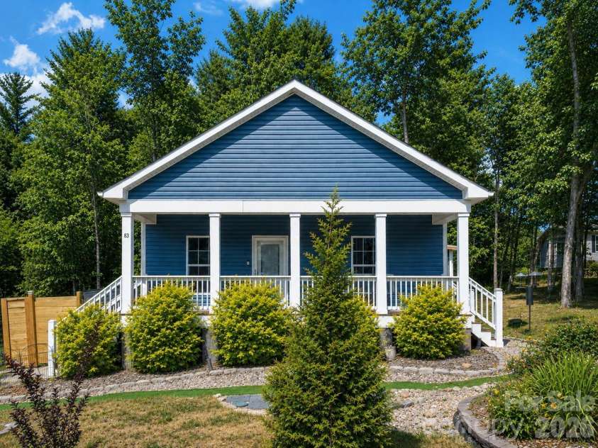 83 Moss Hill Drive, Hendersonville, NC 28792.  MLS# CAR4327286, YatesRealty ID 7589. Landscaping AI enhanced for summer