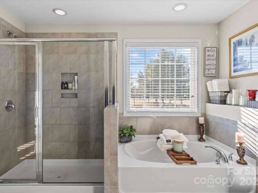 136 Margo Lane, Statesville, NC 28677.  MLS# CAR4214570, YatesRealty ID 7595. Primary en-suite with dual vanities and separate shower and tub