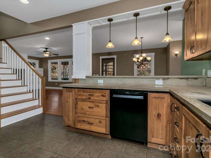241 Fern Way, Black Mountain, NC 28711.  MLS# CAR4196971, YatesRealty ID 7601. Knotty Alder cabinets with concrete countertops.