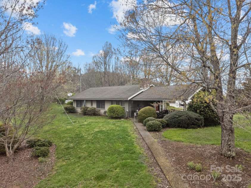 457 Overlook Drive, Spruce Pine, NC 287777.  MLS# CAR4245586, YatesRealty ID 7633. Sloping backyard