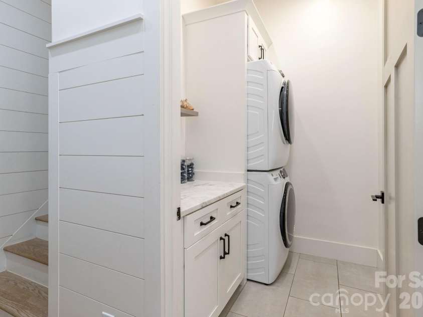 40 Hidden Pond Lane, Brevard, NC 28712.  MLS# CAR4355096, YatesRealty ID 7664. Laundry room off kitchen with stairs to second floor
