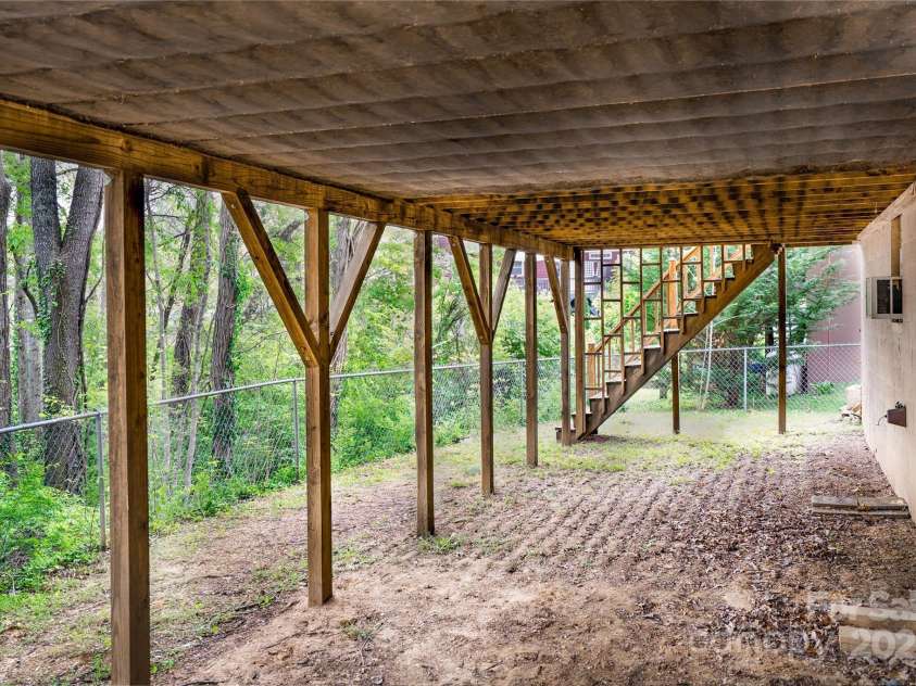 61 Bull Mountain Road, Asheville, NC 28805.  MLS# CAR4216001, YatesRealty ID 7664. Fenced area under the deck and side yard.