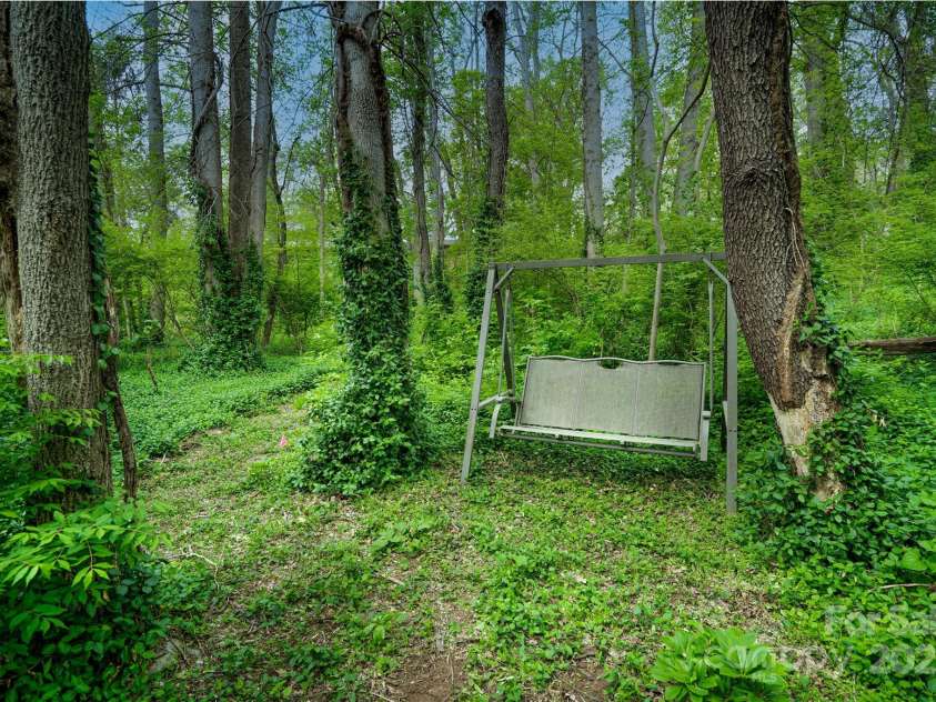 61 Bull Mountain Road, Asheville, NC 28805.  MLS# CAR4216001, YatesRealty ID 7664. Relaxing sitting area in the woods!