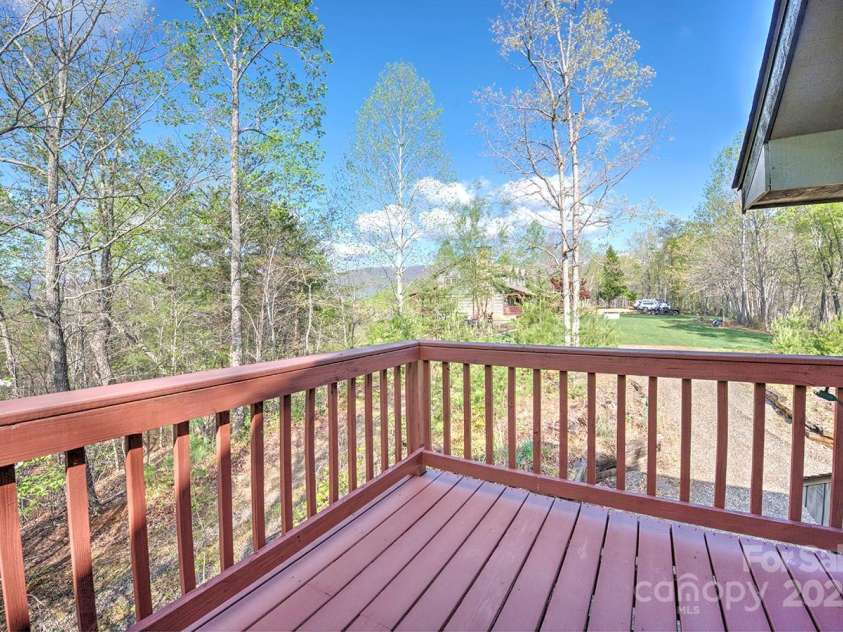 723 Highland Road, Mill Spring, NC 28756.  MLS# CAR4244652, YatesRealty ID 7670. Deck off guest cottage