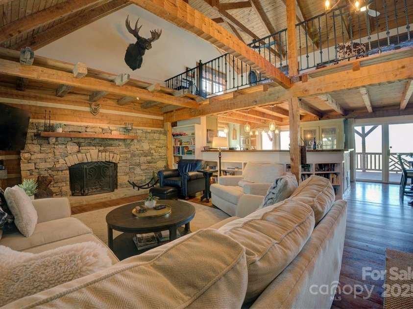 723 Highland Road, Mill Spring, NC 28756.  MLS# CAR4244652, YatesRealty ID 7670. Living room with wood burning fireplace