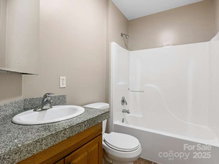 515 Pond Road, Asheville, NC 28806.  MLS# CAR4180837, YatesRealty ID 7674. A full bathroom with a door into the basement bedroom to make this a wonderful private retreat.