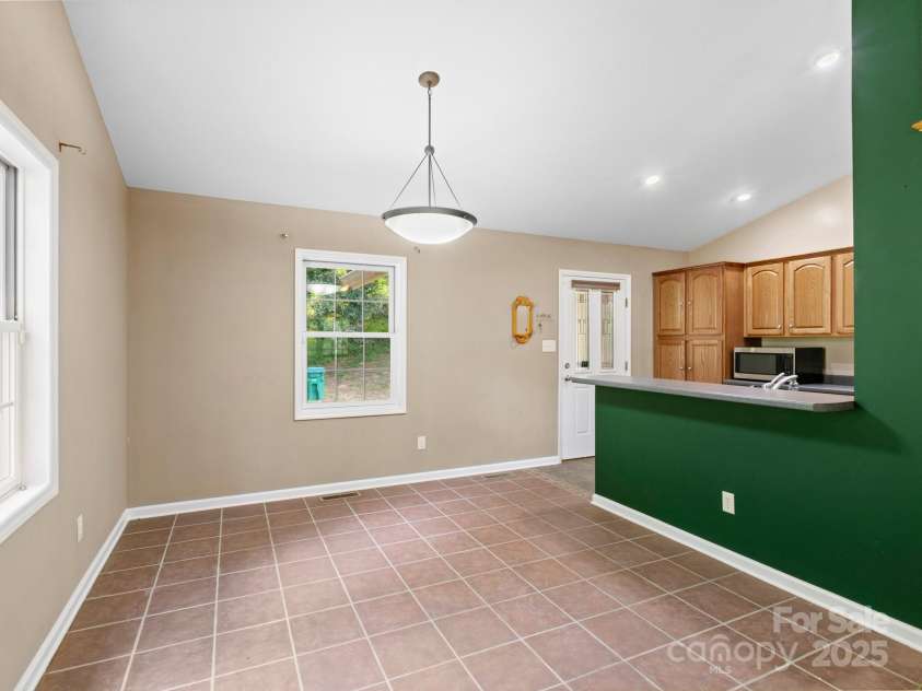 515 Pond Road, Asheville, NC 28806.  MLS# CAR4180837, YatesRealty ID 7674. The kitchen area has its own covered entry to make unloading the groceries easy!