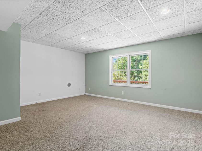 515 Pond Road, Asheville, NC 28806.  MLS# CAR4302486, YatesRealty ID 7674. Downstairs bedroom shown as is, with no furniture added