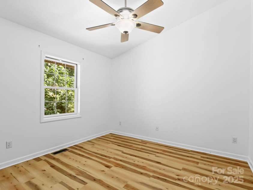 515 Pond Road, Asheville, NC 28806.  MLS# CAR4302486, YatesRealty ID 7674. Gorgeous new LVP flooring shining bright in upstairs secondary bedroom. Picture shown as is,without addition of furniture.